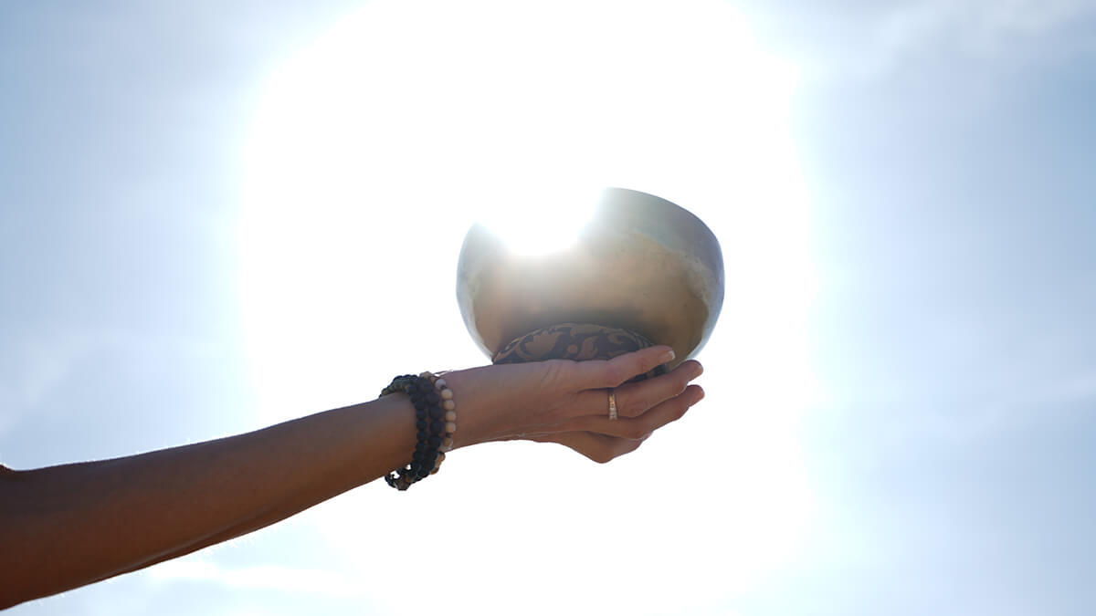 Cary holding Tibetan sound bowl during sound healing